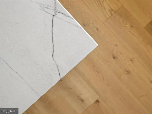 a view of an empty room with window and fire place