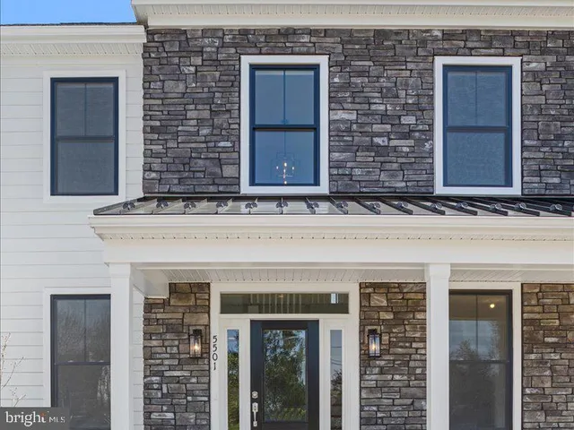 a view of an entryway with wooden floor and door