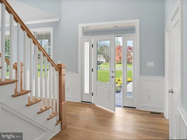 a front view of a house with a white door and wooden floor
