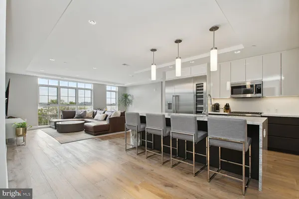 a large kitchen with a table and chairs