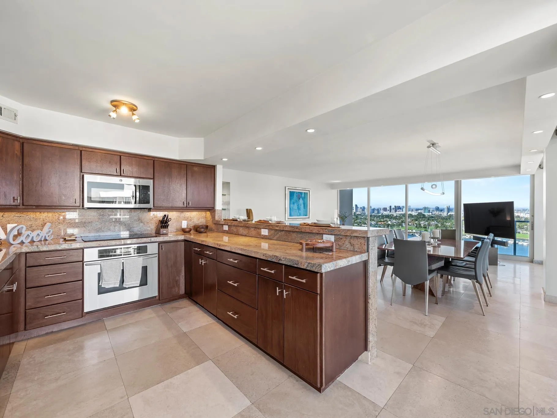 1730 Avenida Del Mundo, Unit 1503 Coronado, CA 92118 - Photo 13 of 47 a kitchen with a stove top oven sink and cabinets