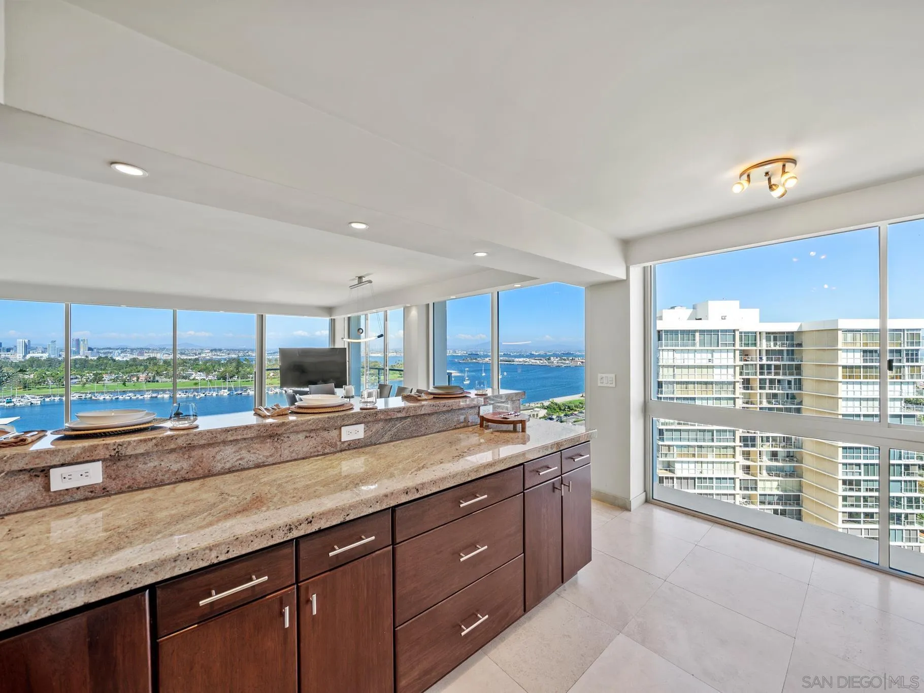 1730 Avenida Del Mundo, Unit 1503 Coronado, CA 92118 - Photo 14 of 47 a open kitchen with kitchen island granite countertop a large window and a counter space