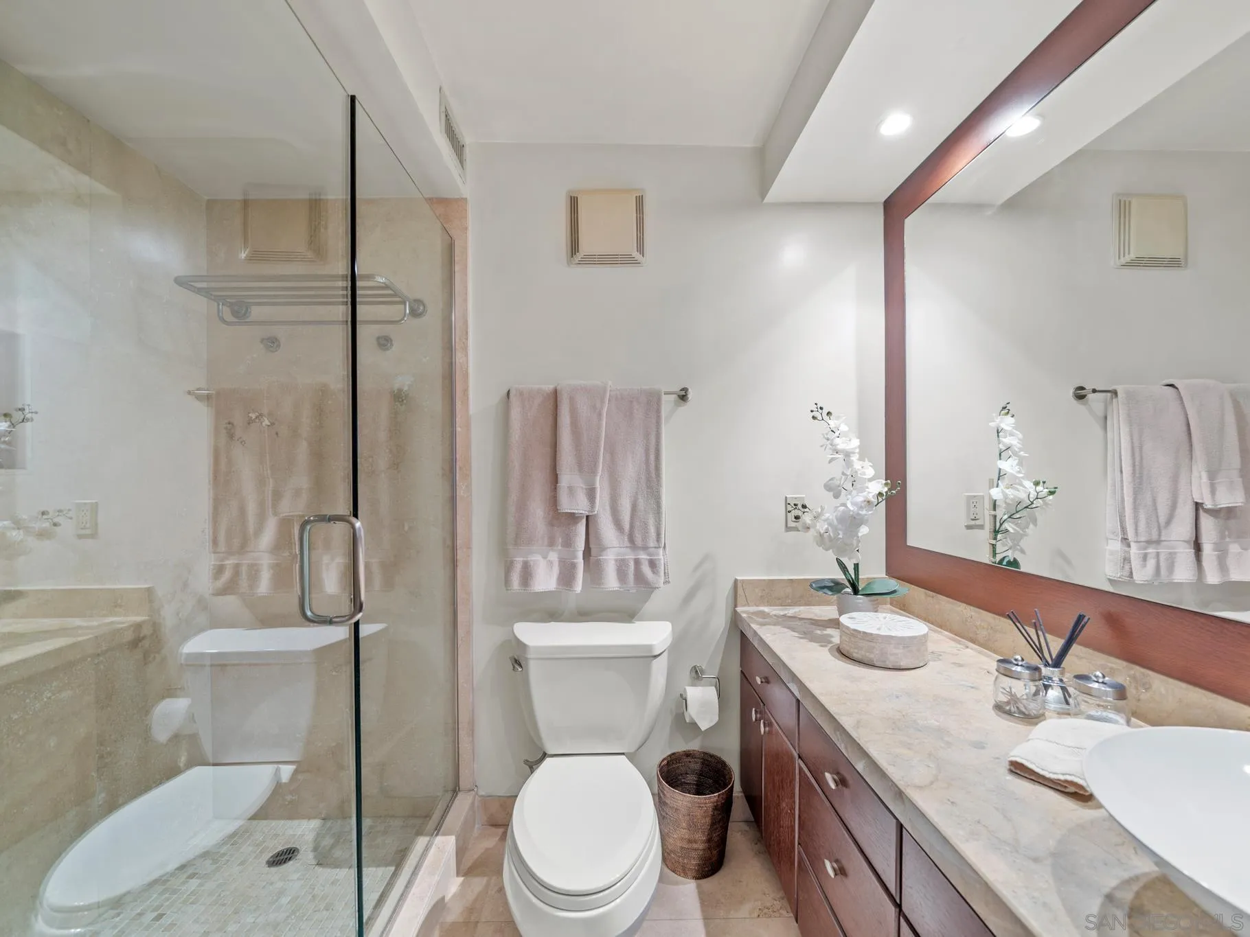 1730 Avenida Del Mundo, Unit 1503 Coronado, CA 92118 - Photo 19 of 47 a bathroom with a sink toilet a mirror and shower