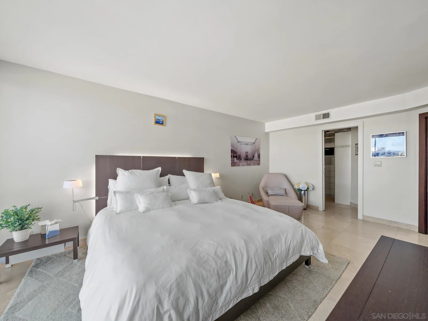 1730 Avenida Del Mundo, Unit 1503 Coronado, CA 92118 - Photo 23 of 47 a bedroom with bed and a night stand