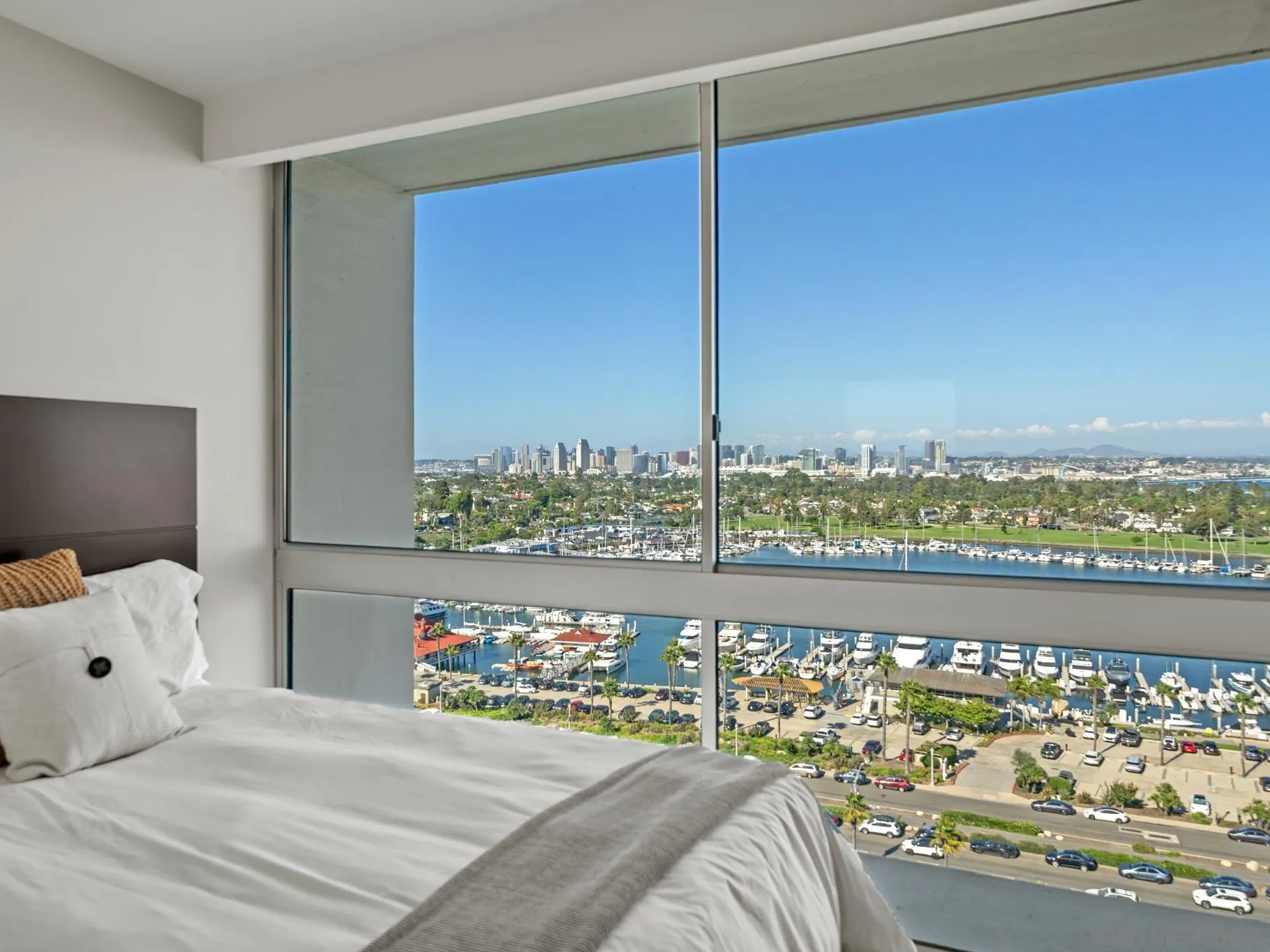 1730 Avenida Del Mundo, Unit 1503 Coronado, CA 92118 - Photo 30 of 47 a bed sitting in a bedroom next to a window