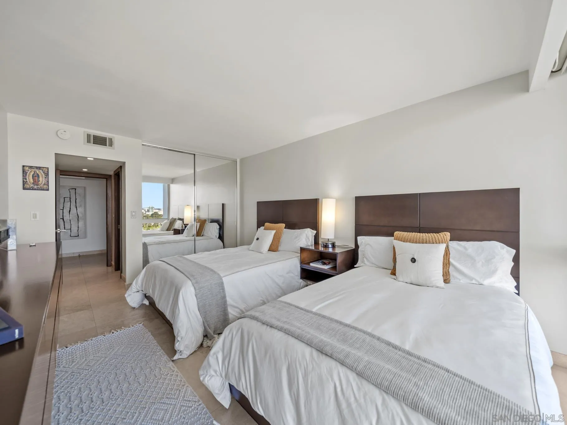 1730 Avenida Del Mundo, Unit 1503 Coronado, CA 92118 - Photo 31 of 47 a bedroom with two beds and a night stand