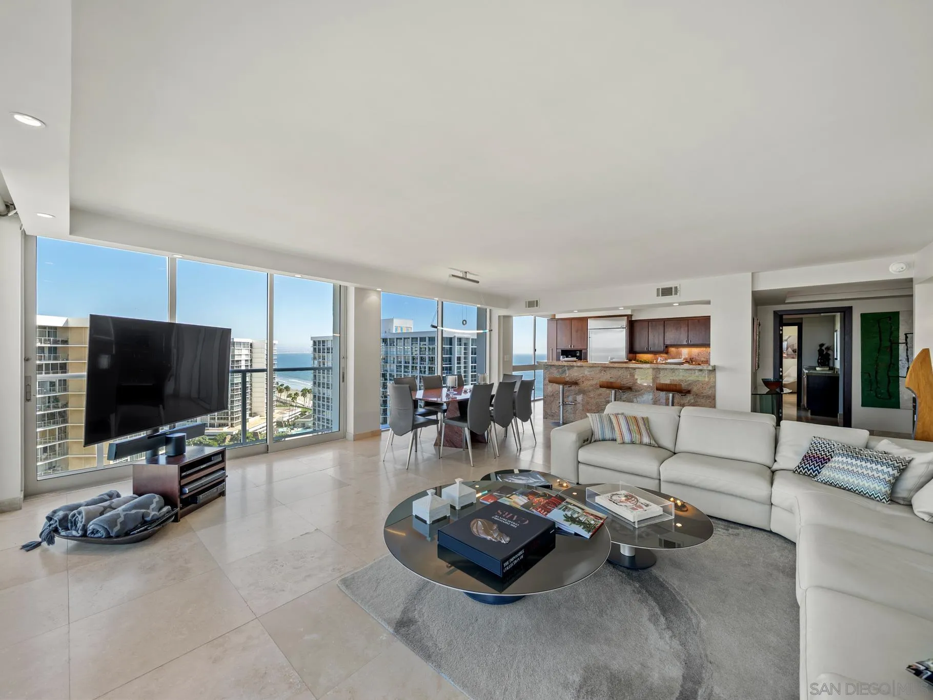 1730 Avenida Del Mundo, Unit 1503 Coronado, CA 92118 - Photo 7 of 47 a living room with furniture and a flat screen tv