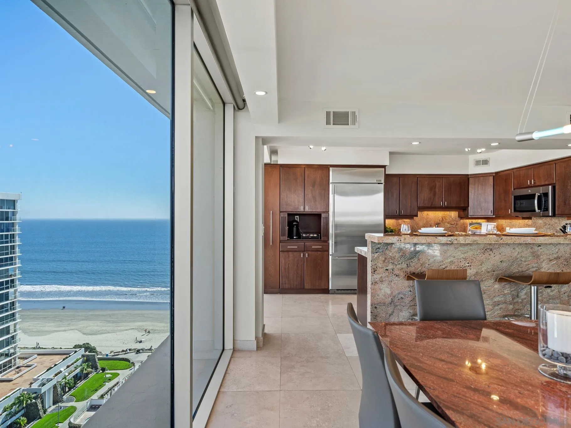 1730 Avenida Del Mundo, Unit 1503 Coronado, CA 92118 - Photo 9 of 47 a kitchen with stainless steel appliances granite countertop a refrigerator a stove and a sink with wooden floor