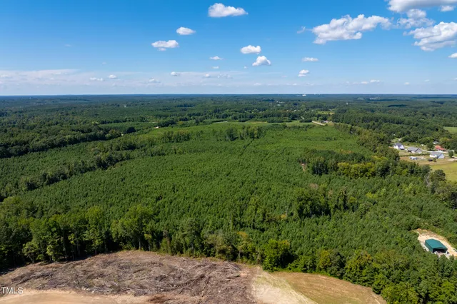 a view of a big yard with lots of green space and mountain view
