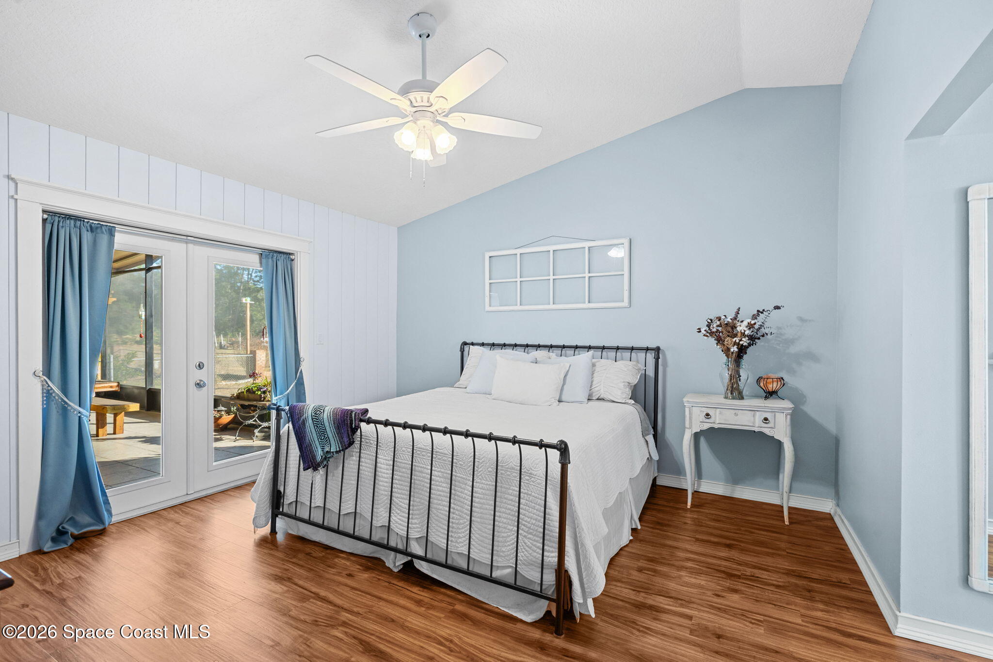 4475 Lemon Street Cocoa, FL 32926 - Photo 31 of 41 a bedroom with a large bed and a chandelier