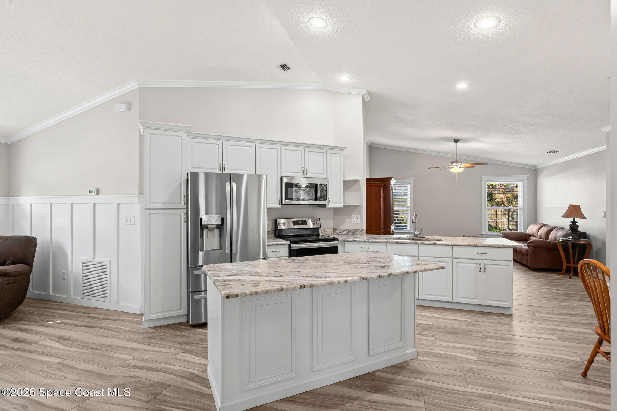 4475 Lemon Street Cocoa, FL 32926 - Photo 6 of 41 a kitchen with white cabinets and stainless steel appliances