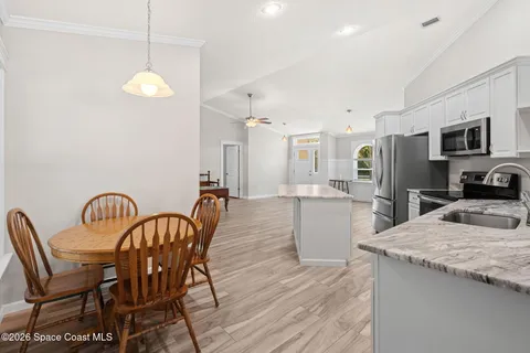 a large kitchen with a table and chairs