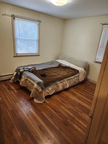 a bed sitting in a bedroom next to a window