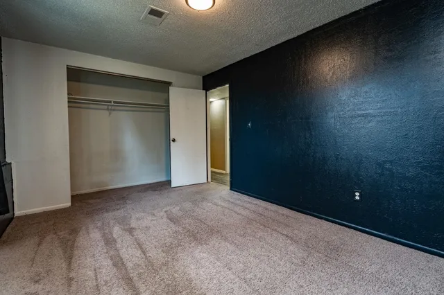 an empty room with closet area