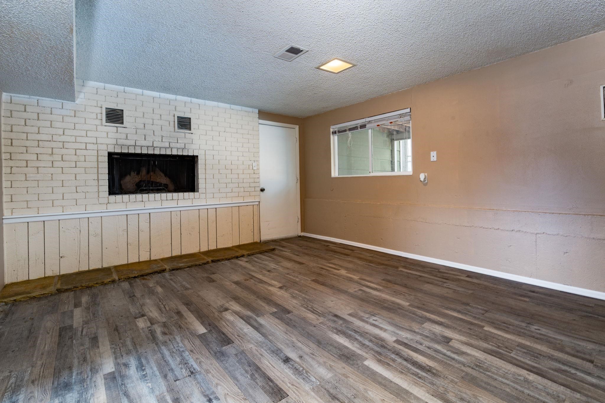 559 Court Road Grand Junction, CO 81501 - Photo 20 of 28 a view of an empty room with a fireplace and a window