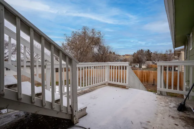 a view of a balcony with wooden fence and floor