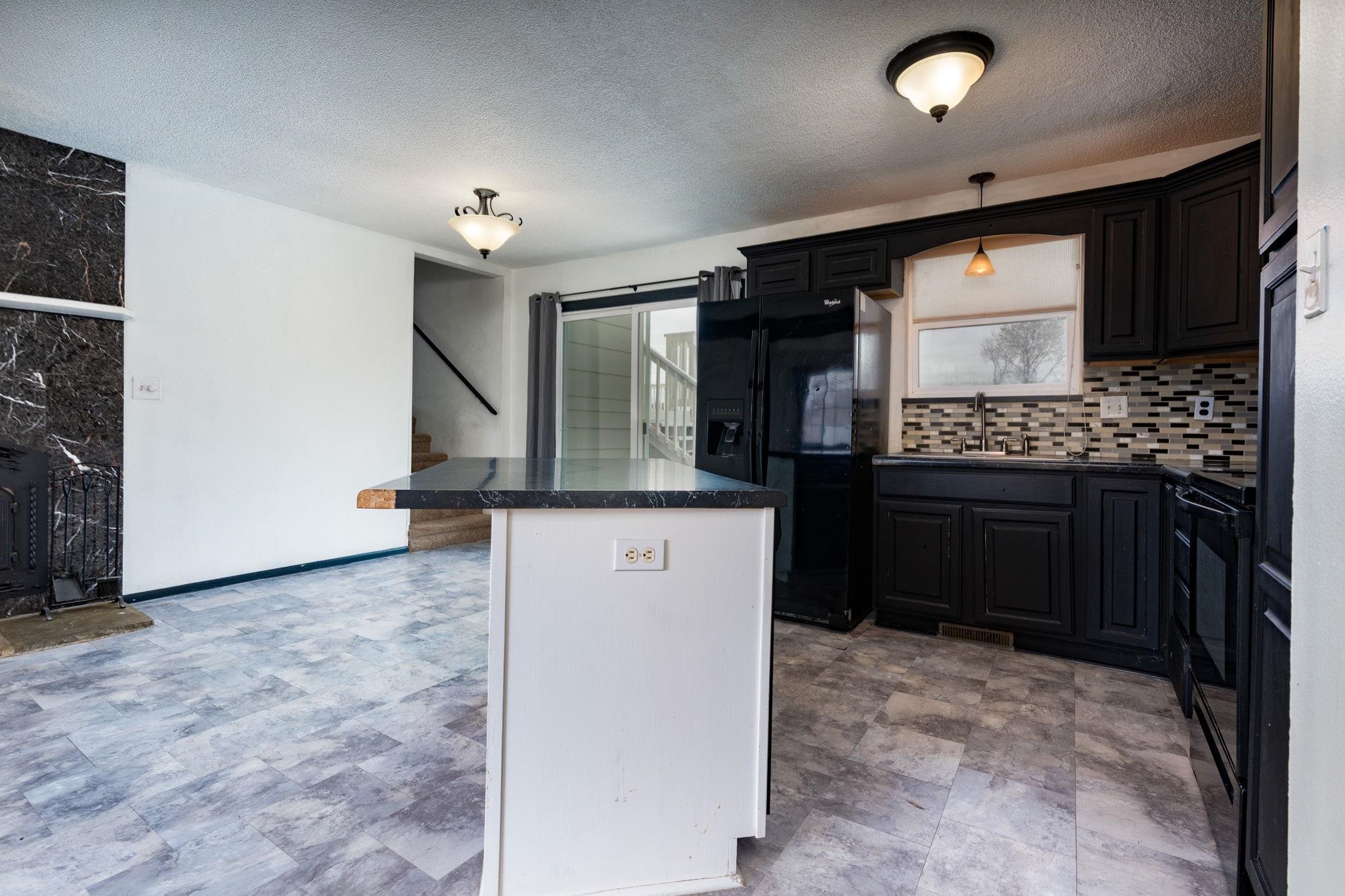 559 Court Road Grand Junction, CO 81501 - Photo 6 of 28 a kitchen with stainless steel appliances granite countertop a stove a sink and a refrigerator