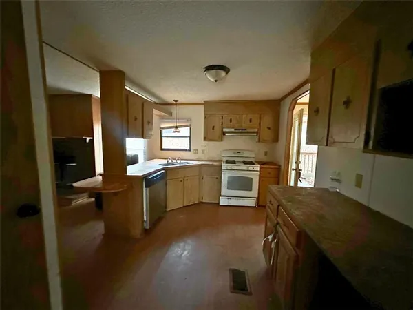 a kitchen with a sink appliances and cabinets