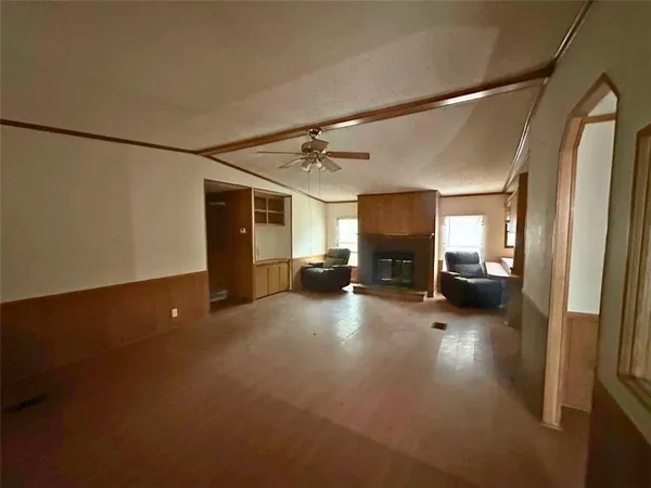 a view of a livingroom with furniture and a hallway