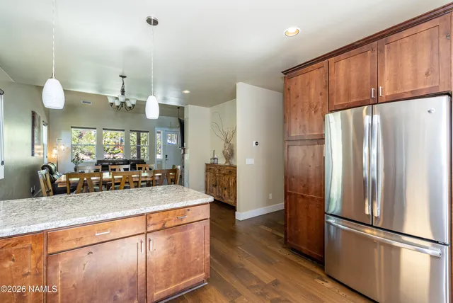 a kitchen with stainless steel appliances granite countertop a refrigerator a sink and a stove