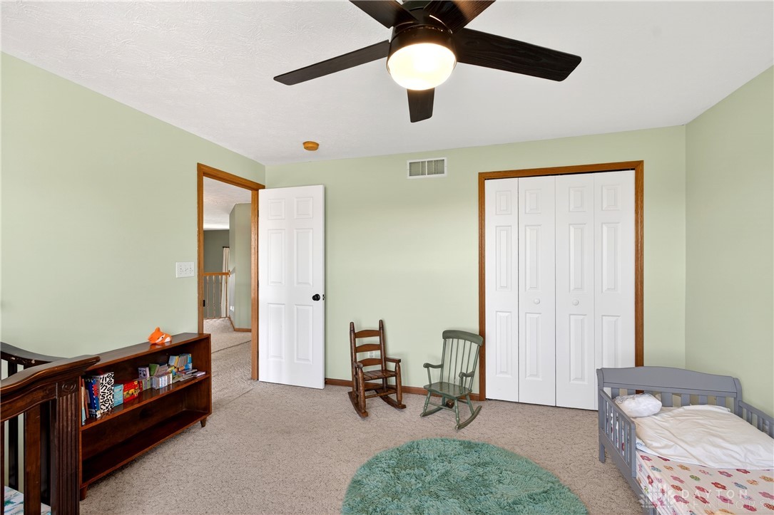 6560 Snyder Road Fletcher, OH 45326 - Photo 37 of 71 This spacious bedroom offers comfortable carpeting and a convenient bi-fold closet, creating a cozy atmosphere.