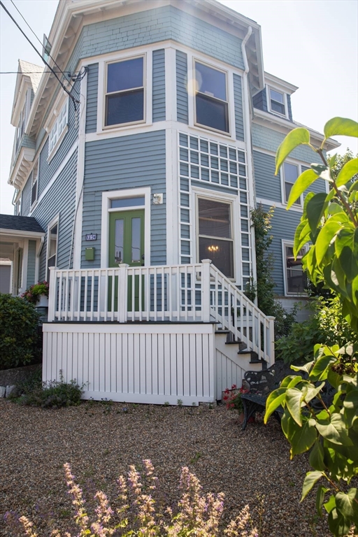 a view of a house with a yard and wooden fence