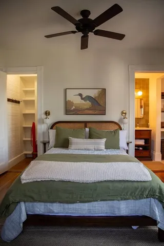 a bedroom with a bed and wooden floor