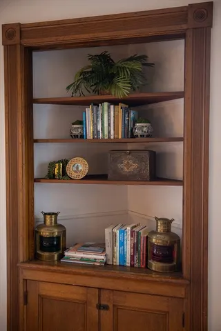 a shelf with books and knick knacks on it