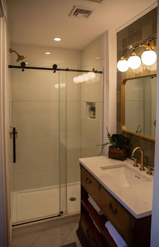 a bathroom with a sink a toilet and shower