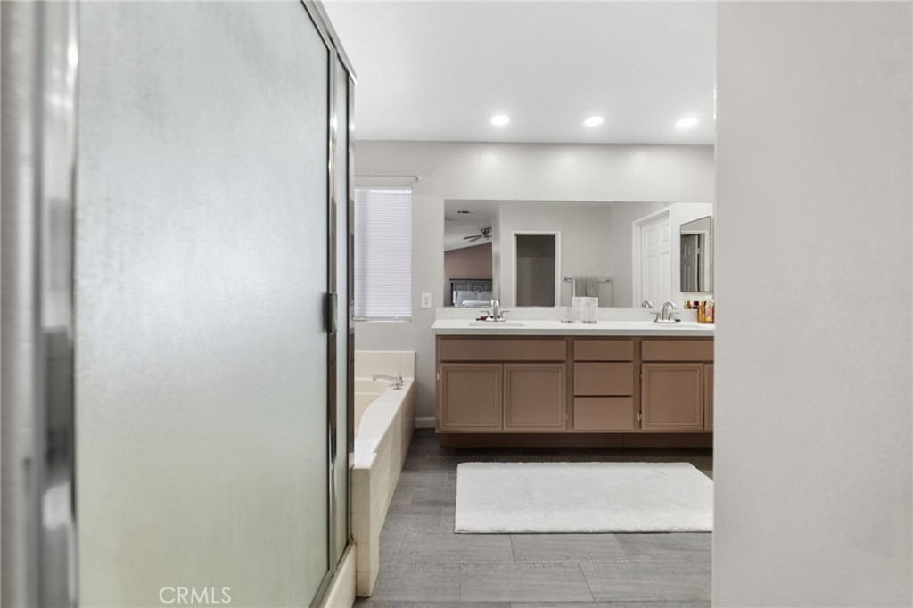 1494 Rabbit Peak Way Hemet, CA 92545 - Photo 26 of 45 a bathroom with a sink a mirror and vanity