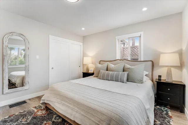 a bedroom with a bed and a mirror