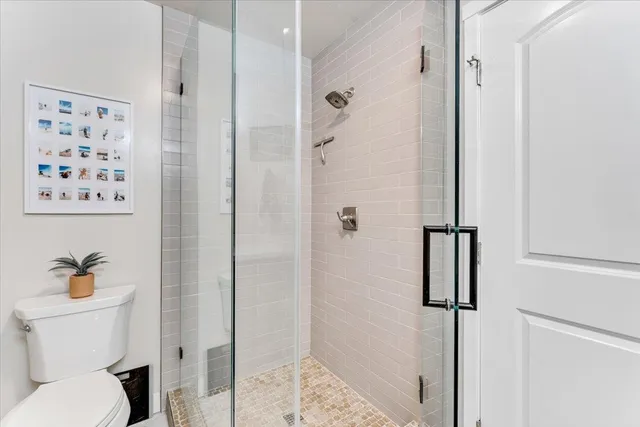 a bathroom with a toilet and a shower