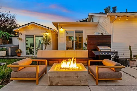 a view of a house with a swimming pool and a yard