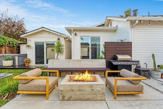 a view of a house with swimming pool and sitting area