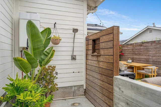 a backyard of a house with wooden floor outdoor seating and yard