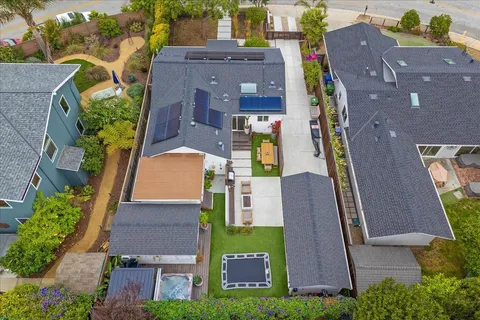 a front view of a house with a garden and trees
