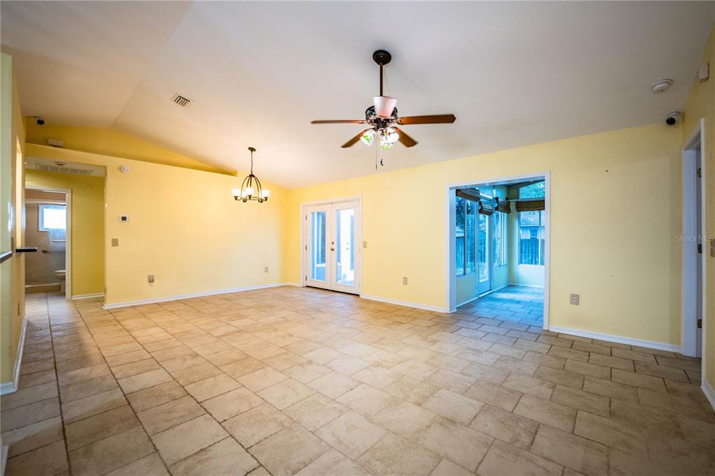 2724 Sundance Place Mulberry, FL 33860 - Photo 16 of 40 a view of a livingroom with a chandelier fan and windows