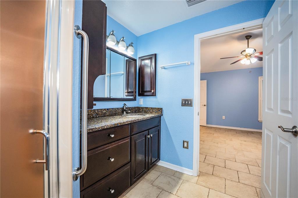 2724 Sundance Place Mulberry, FL 33860 - Photo 23 of 40 a bathroom with a granite countertop sink mirror and toilet