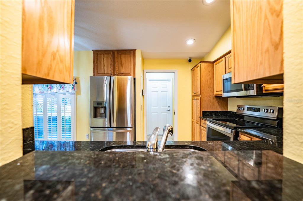 2724 Sundance Place Mulberry, FL 33860 - Photo 10 of 40 a view of a kitchen with stainless steel appliances a stove and a window