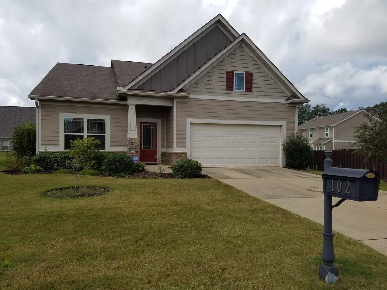 102 Mere Way LaGrange, GA 30241 - Photo 1 of 1 a front view of a house with a yard and garage