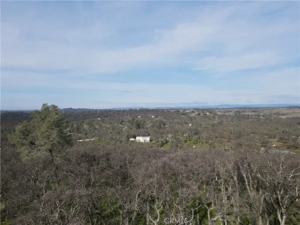 a view of a backyard with table and chairs and wooden fence