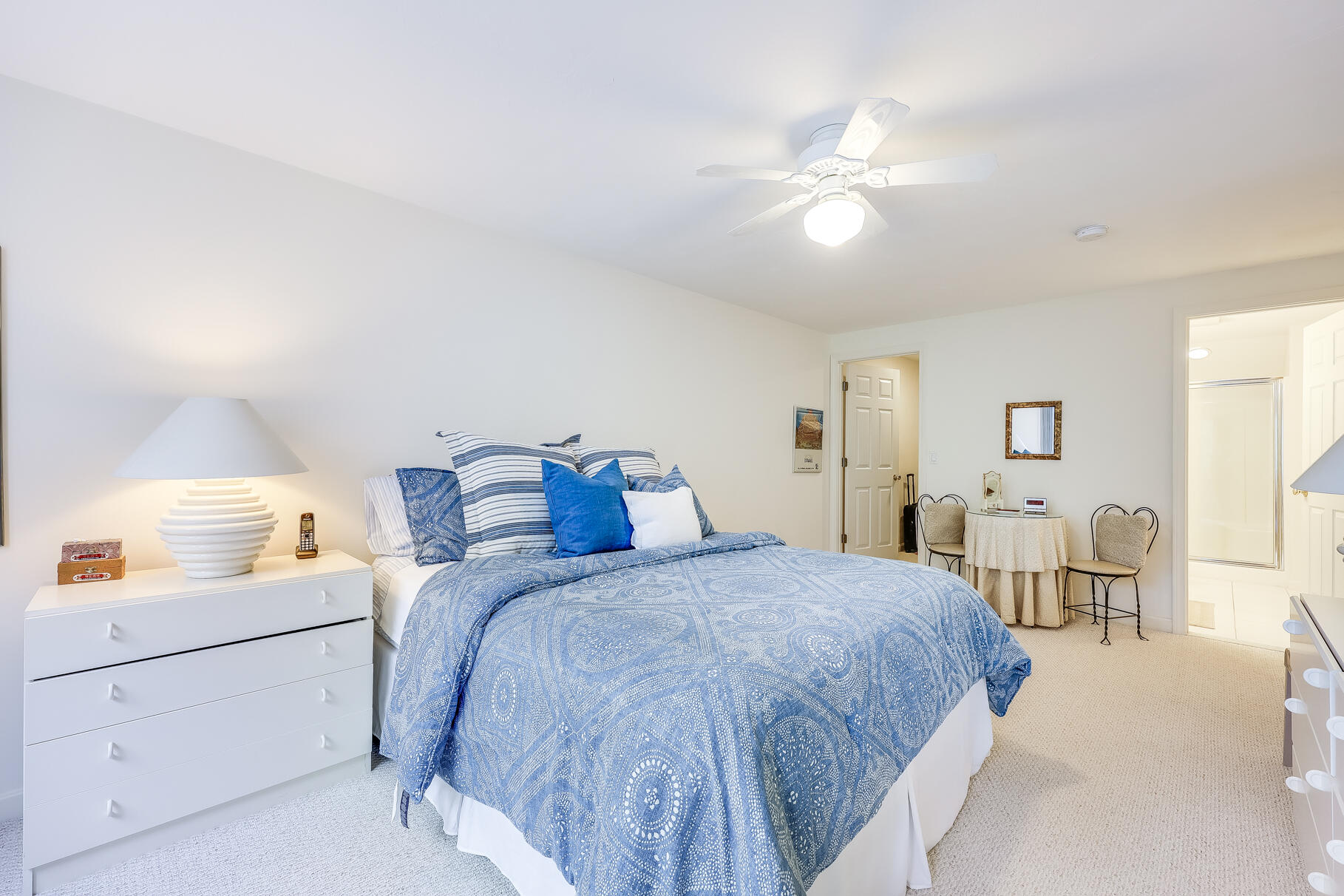 23 Longwood Road Mashpee, MA 02649 - Photo 30 of 66 a spacious bedroom with a bed and a chandelier