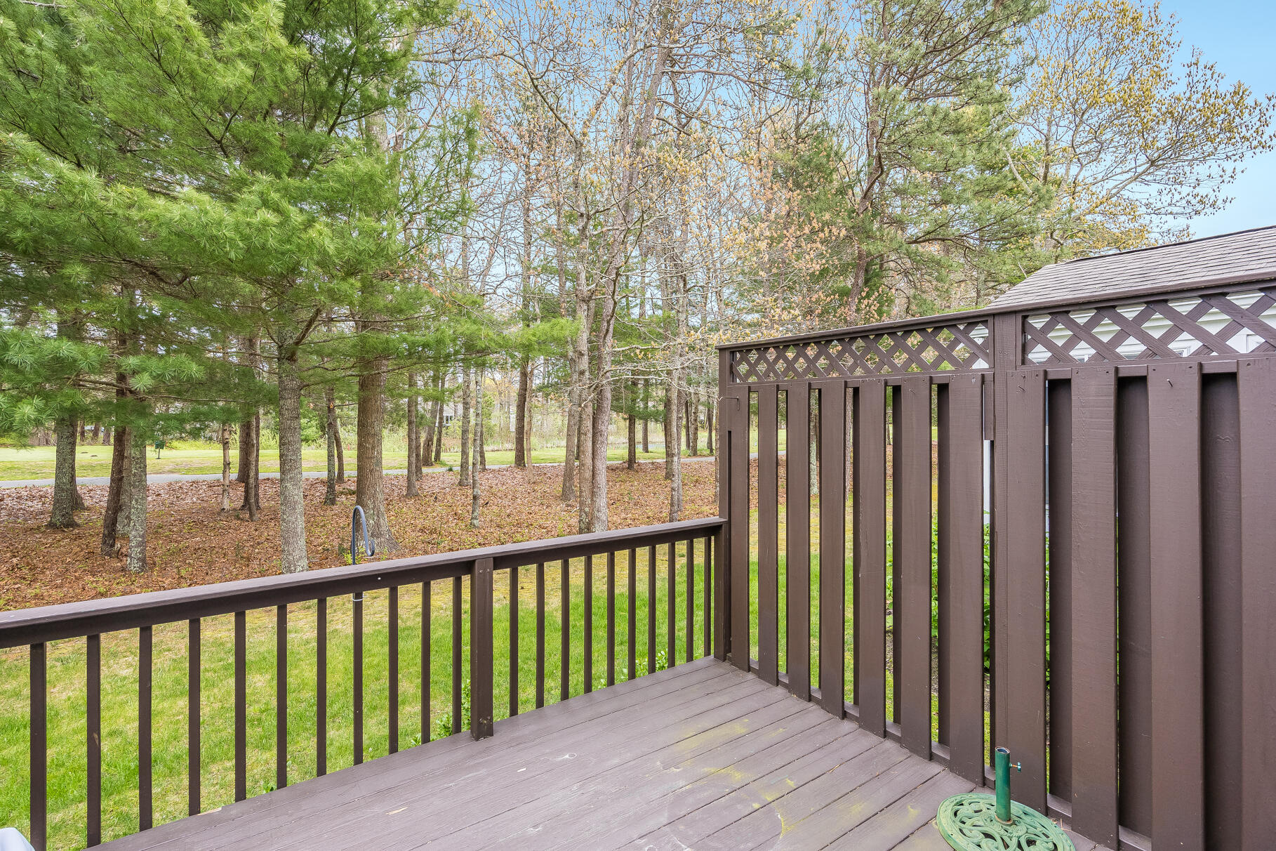 23 Longwood Road Mashpee, MA 02649 - Photo 3 of 66 a balcony with trees in front of it