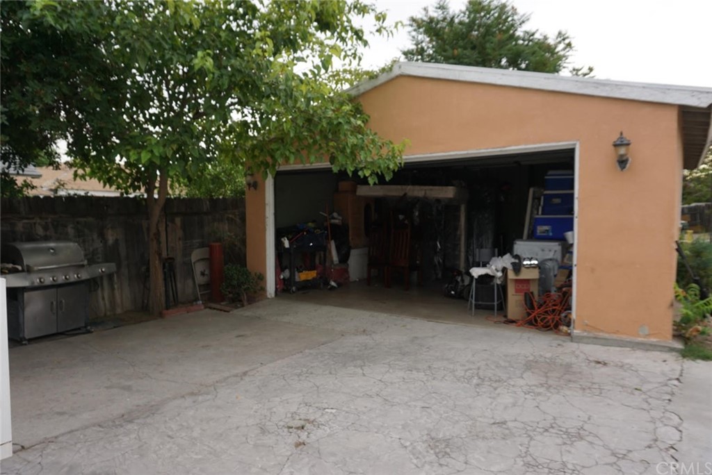 9864 Cedar Avenue Bloomington, CA 92316 - Photo 12 of 15 a view of a patio with table and chairs under an umbrella