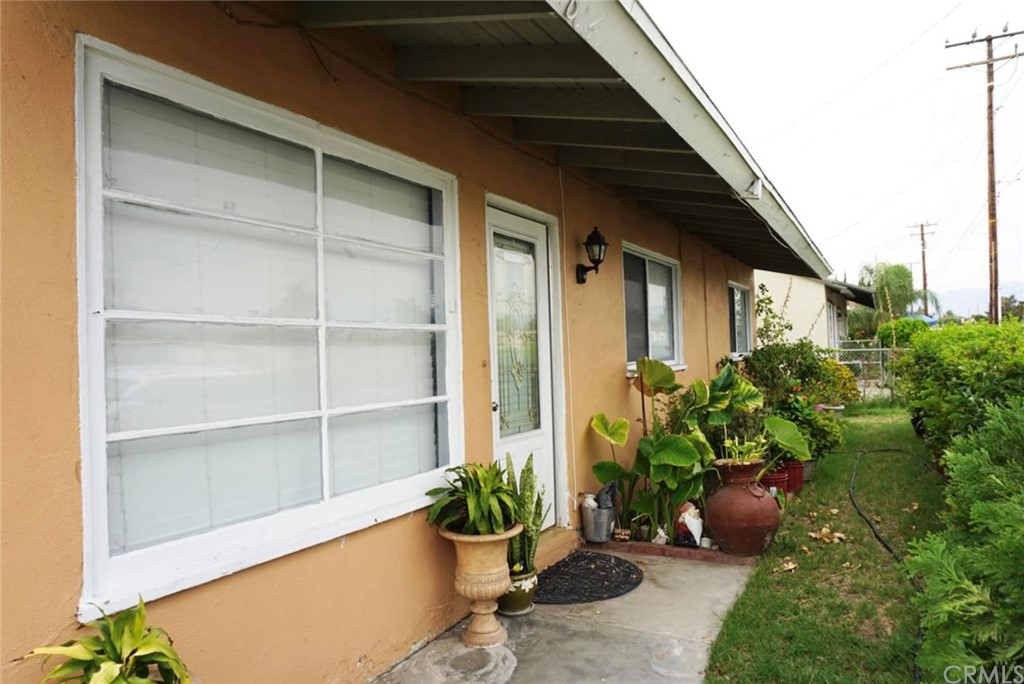 9864 Cedar Avenue Bloomington, CA 92316 - Photo 2 of 15 a potted plant sitting in front of a house