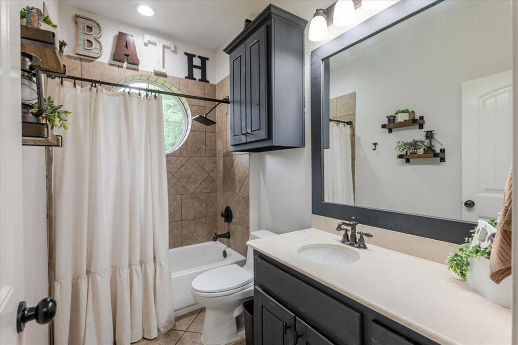 318 East Lone Star Road Poolville, TX 76487 - Photo 12 of 33 a bathroom with a sink vanity mirror and toilet