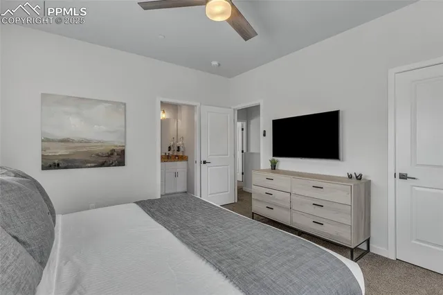 a bedroom with a bed and flat screen tv