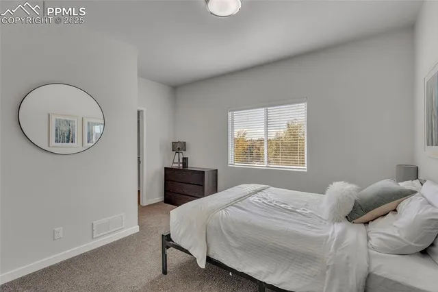 a bedroom with a bed and a mirror