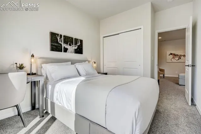 a bedroom with a bed and a night stand