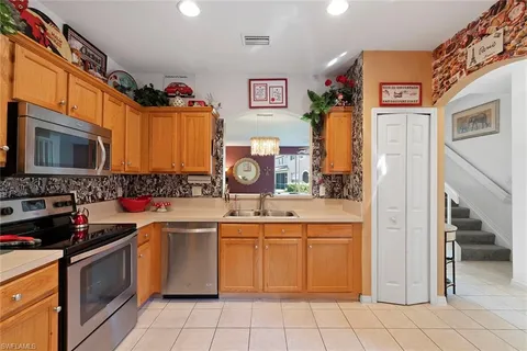 a kitchen with stainless steel appliances a stove sink and cabinets